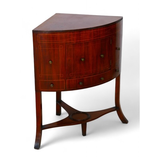 340 - A George III mahogany line inlaid Sheraton corner washstand, with fold down top enclosing a fitted i... 