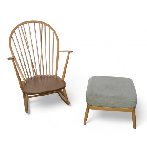 332 - An Ercol beech stick back rocking chair, together with an upholstered footstool. (2)