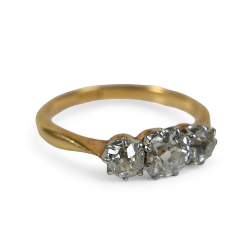 62 - An 18ct yellow gold three stone diamond ring, the central diamond approximately 4.5mm by 3mm 0.35ct,... 