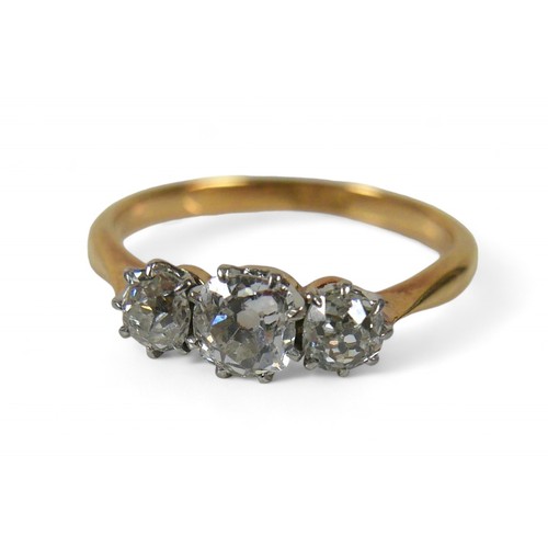 62 - An 18ct yellow gold three stone diamond ring, the central diamond approximately 4.5mm by 3mm 0.35ct,... 