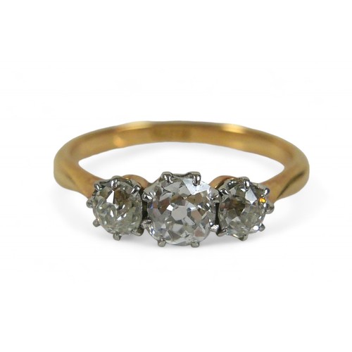 62 - An 18ct yellow gold three stone diamond ring, the central diamond approximately 4.5mm by 3mm 0.35ct,... 