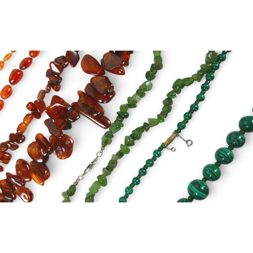 12 - A collection of eleven necklaces including amber and jet, also a horn necklace. (1 bag)