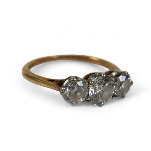 4 - An 18ct yellow gold three stone diamond ring, the central diamond approximately 4.8mm by 3mm 0.40ct,... 