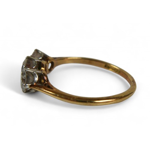 4 - An 18ct yellow gold three stone diamond ring, the central diamond approximately 4.8mm by 3mm 0.40ct,... 