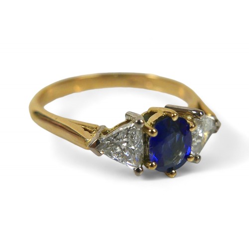 64 - An 18ct gold natural blue sapphire and diamond ring, the oval cut sapphire, approximately 4 by 5mm, ... 