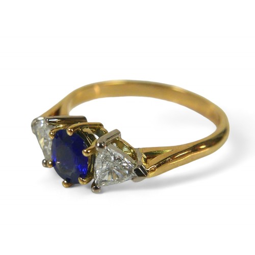 64 - An 18ct gold natural blue sapphire and diamond ring, the oval cut sapphire, approximately 4 by 5mm, ... 