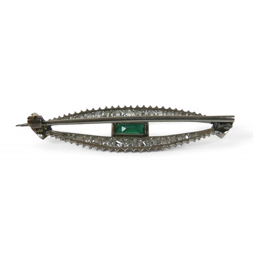 51 - A white gold emerald and diamond bar brooch, emerald 3.5 by 5mm, 3.8cm wide, 3.1g.