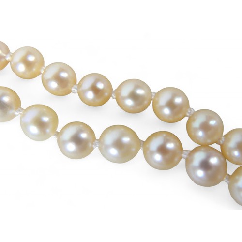 10 - A pearl necklace with 14ct white gold diamond and emerald clasp, the round cut emerald3mm diameter, ... 