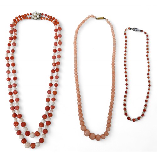 39 - Three coral necklaces, two with 14ct white gold clasps and pearls, longest 45cm long, 65.2g gross.