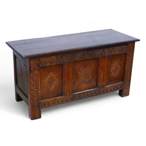 337 - An oak coffer with a carved front, 119 by 47 by 60cm high.