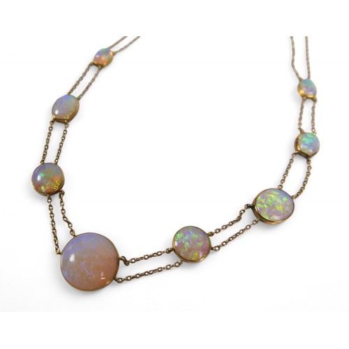 65 - An opal and yellow metal double strand necklace, made up of nine opals of graduating sizes, the cent... 