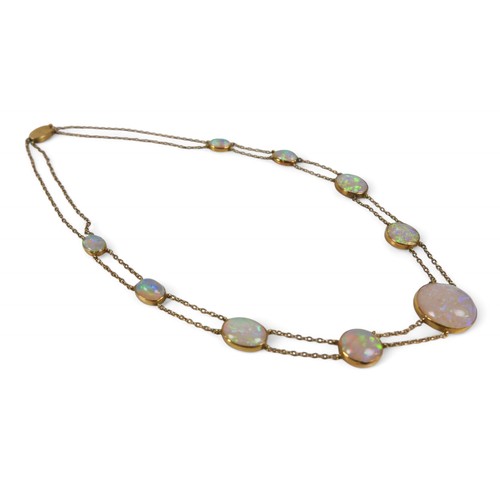 65 - An opal and yellow metal double strand necklace, made up of nine opals of graduating sizes, the cent... 