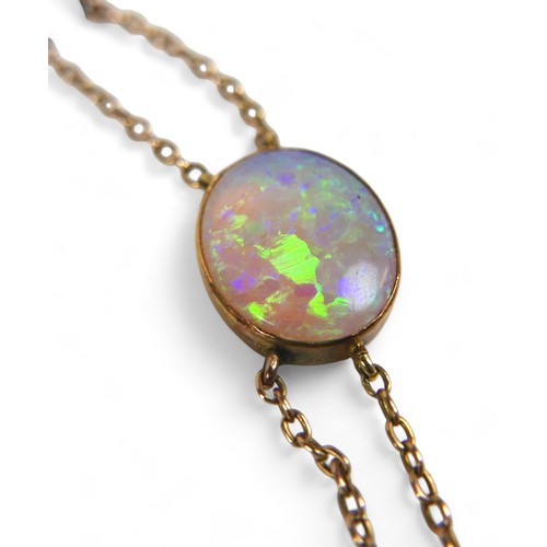 65 - An opal and yellow metal double strand necklace, made up of nine opals of graduating sizes, the cent... 