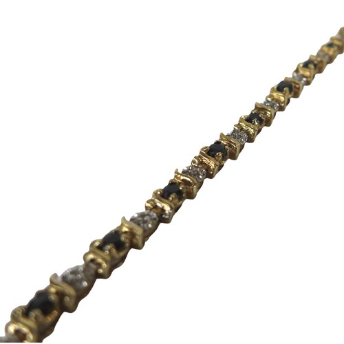 34 - A 9ct gold tennis bracelet, interspersed with blue and white stones, 19cm long, 6.8g.