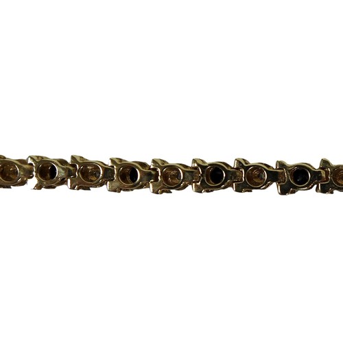 34 - A 9ct gold tennis bracelet, interspersed with blue and white stones, 19cm long, 6.8g.