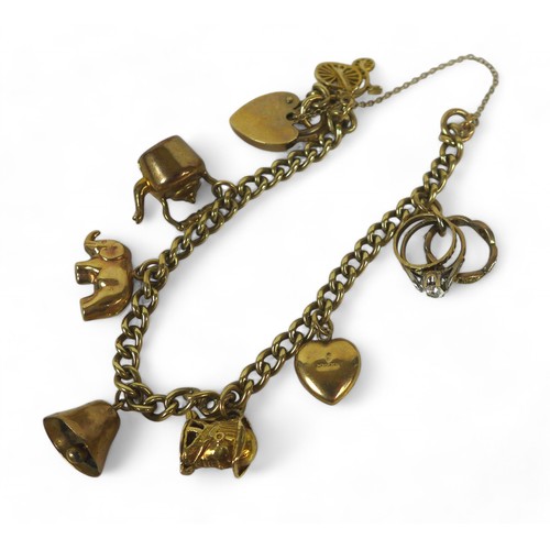 72 - A 9ct gold charm bracelet, fitted with seven charms and padlock clasp with safety chain, 19.3g.