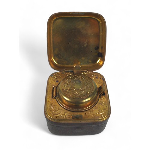 164 - A vintage travel leather covered ink well, with glass bottle and brass interior, 6 by 6 by 4.5cm.