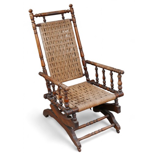 312 - A mahogany American rocking chair, 57 by 77 by 102cm high.