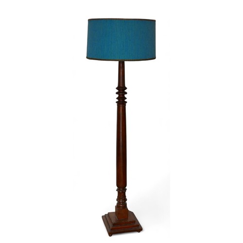 308 - An early 20th century mahogany standard lamp, with blue shade and turned support, 177cm high.