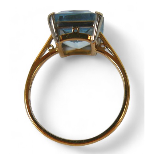 53 - An 18ct gold aquamarine ring, the emerald cut stone, 10 by12mm, size M, 3.2g.