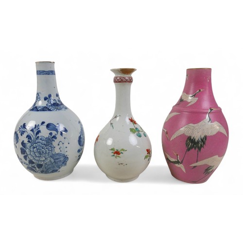 173 - Three oriental bottle vases, one with pink ground and cranes in flight, largest 15cm diameter 25cm h... 