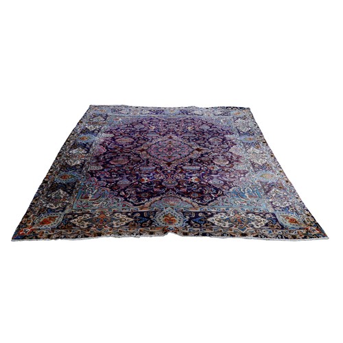 385 - A Persian hand knotted woolen carpet, with a blue field and stylized border, 405 by 308cm.