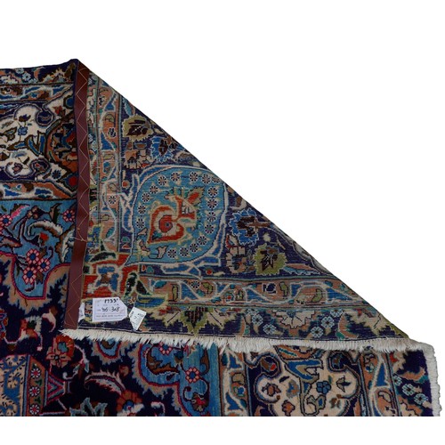 385 - A Persian hand knotted woolen carpet, with a blue field and stylized border, 405 by 308cm.