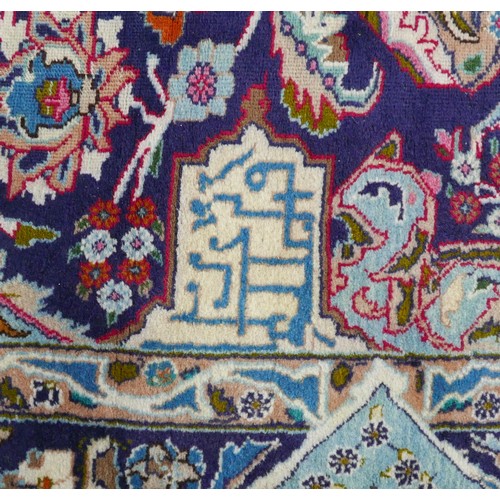 385 - A Persian hand knotted woolen carpet, with a blue field and stylized border, 405 by 308cm.