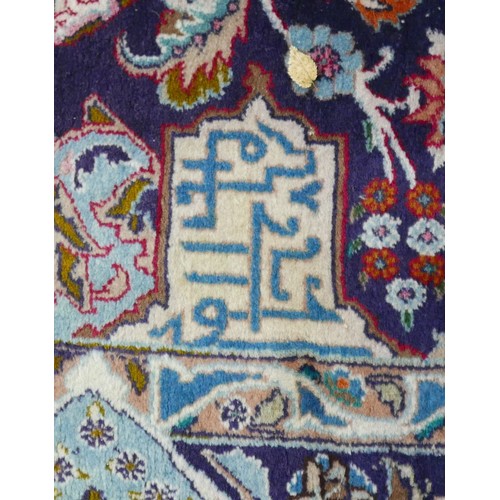 385 - A Persian hand knotted woolen carpet, with a blue field and stylized border, 405 by 308cm.