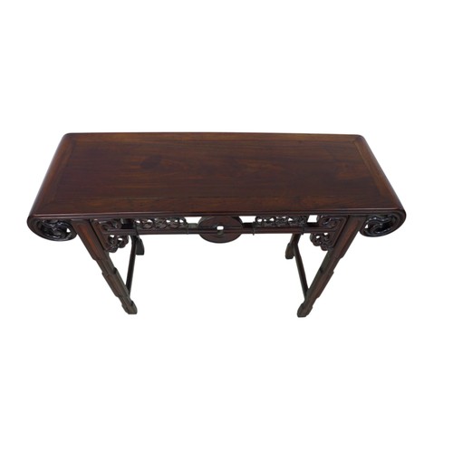 384 - A Chinese hardwood altar table, with a carved frieze, 118 by 39 by 84cm high.