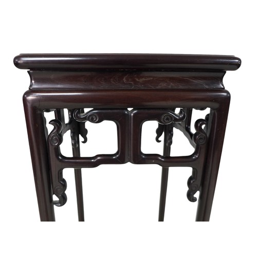 377 - A Chinese hardwood jardiniere stand, with a carved frieze, 34 by 34 by 101cm high.