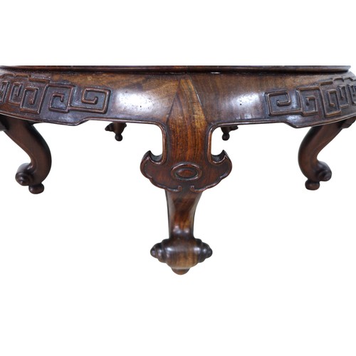 378 - A Chinese circular hardwood opium table, with a relief decorated frieze on four scroll feet, 77cm di... 