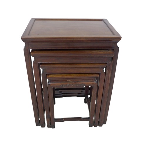 365 - A nest of four Chinese hardwood side tables, with relief decorated frieze, 51 by 36 by 67cm high.