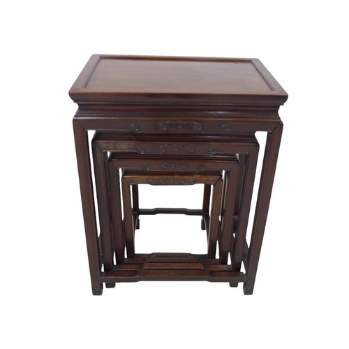 365 - A nest of four Chinese hardwood side tables, with relief decorated frieze, 51 by 36 by 67cm high.