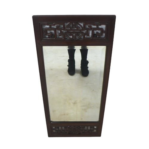 353 - A Chinese hardwood framed wall mirror, with carved detail, 45 by 3 by 101cm high.