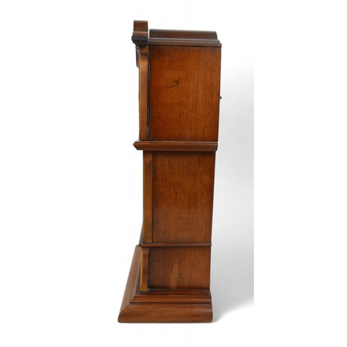 276 - A mahogany mantle clock in the form of a long case clock, 22 by 14 by 46cm high.