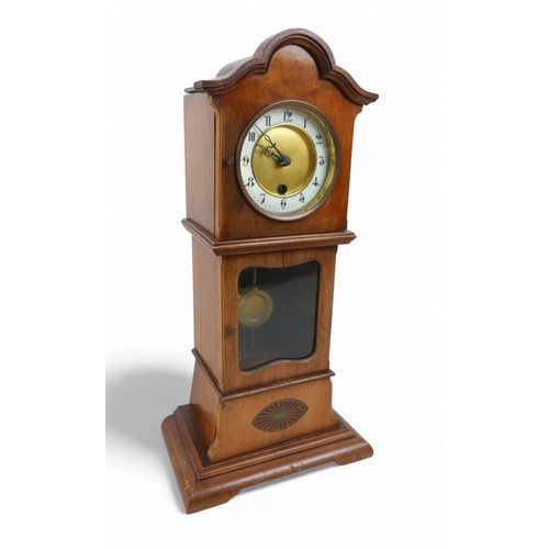 276 - A mahogany mantle clock in the form of a long case clock, 22 by 14 by 46cm high.