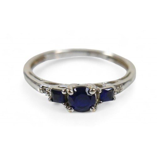 37 - A 9ct white gold and sapphire ring, the round cut central stone, 2.16mm diameter, is flanked by two ... 