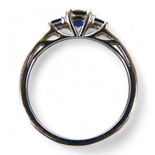 37 - A 9ct white gold and sapphire ring, the round cut central stone, 2.16mm diameter, is flanked by two ... 