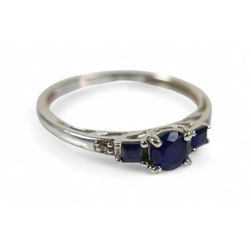 37 - A 9ct white gold and sapphire ring, the round cut central stone, 2.16mm diameter, is flanked by two ... 