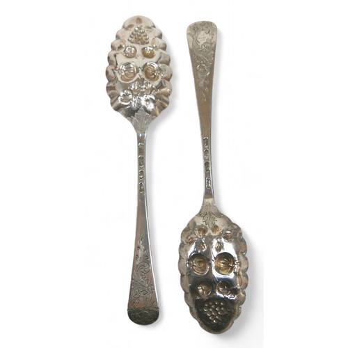 104 - A pair of Georgian silver berry spoons, each with engraved handles, scalloped edge and gilt washed b... 