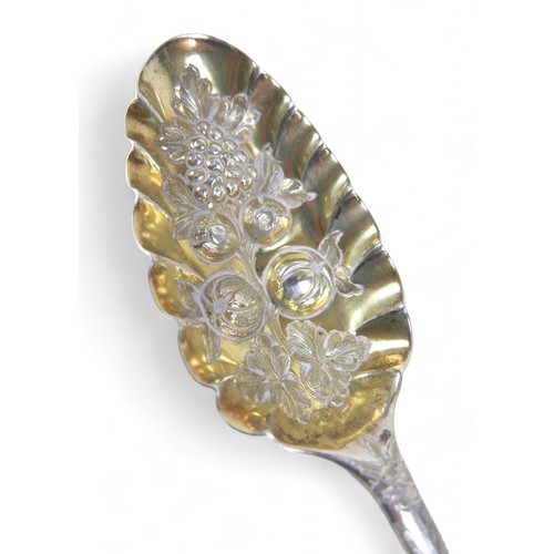 104 - A pair of Georgian silver berry spoons, each with engraved handles, scalloped edge and gilt washed b... 