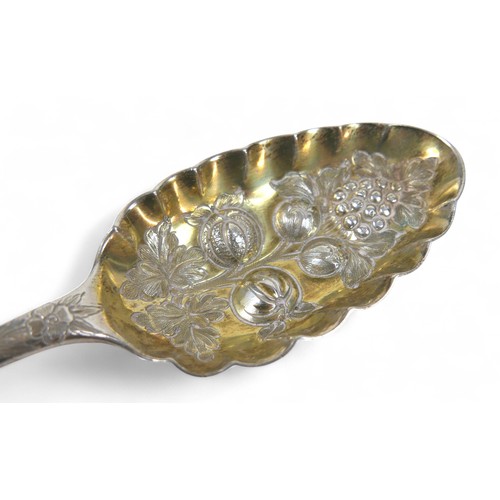 104 - A pair of Georgian silver berry spoons, each with engraved handles, scalloped edge and gilt washed b... 