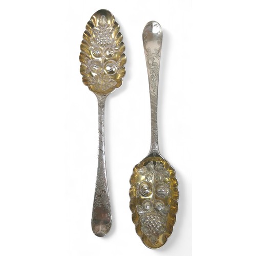 104 - A pair of Georgian silver berry spoons, each with engraved handles, scalloped edge and gilt washed b... 