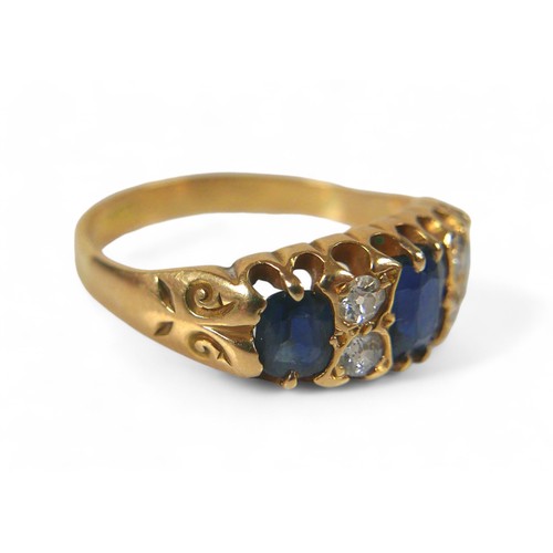 60 - An 18ct gold, sapphire and diamond ring, three oval cut sapphire, the largest, measuring approximate... 