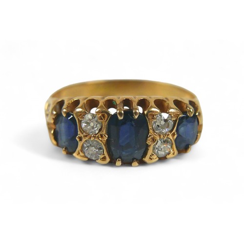 60 - An 18ct gold, sapphire and diamond ring, three oval cut sapphire, the largest, measuring approximate... 