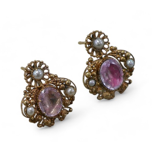 64 - A pair of pink stone and half pearl gold earrings, cannetille work design, each 18 by 18cm, 5.3g ove... 