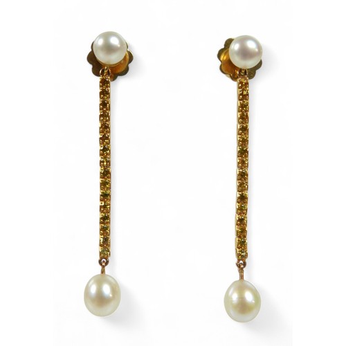 65 - A pair of 18ct gold pearl and yellow sapphire drop earrings, each earring with a two cultured pearls... 