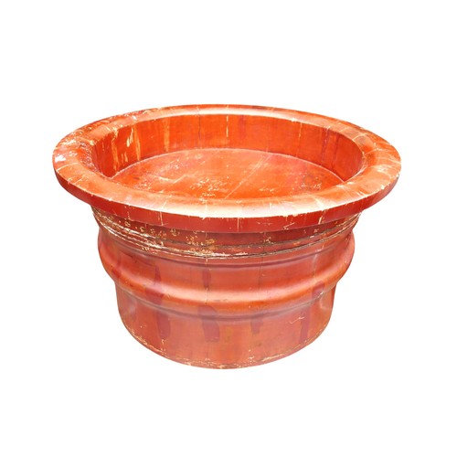 161 - An oriental red lacquer wooden barrel, 78cm diameter 44cm high.