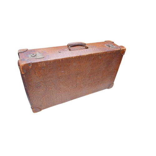 283 - A vintage faux leather faux crocodile suitcase 75 by 42 by 21cm.